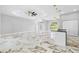 Bright and airy living room with decorative ceiling, modern lighting fixtures, and marble flooring at 5317 Lydia Ct, Spring Hill, FL 34608