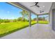 Spacious covered patio with tile flooring, ceiling fans, and views of the expansive backyard at 5317 Lydia Ct, Spring Hill, FL 34608
