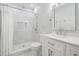 Well-lit bathroom featuring a shower, vanity, white cabinets, and elegant tiling at 5528 Liberty Plain Cir, Tampa, FL 33611
