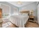 Bedroom featuring a comfortable bed, a nightstand with a lamp, and natural lighting from the windows at 5528 Liberty Plain Cir, Tampa, FL 33611