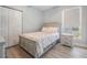 Cozy bedroom with stylish bedframe, neutral tones, and a window for natural light at 5528 Liberty Plain Cir, Tampa, FL 33611