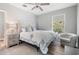 Bright bedroom boasts a decorative headboard, a comfortable chair, and plenty of natural light at 5528 Liberty Plain Cir, Tampa, FL 33611