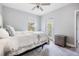 Serene bedroom with natural light, white bedding, and a calming color palette at 5528 Liberty Plain Cir, Tampa, FL 33611