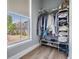 Organized closet space features shelving, hanging rods, and a view of the neighborhood at 5528 Liberty Plain Cir, Tampa, FL 33611