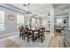 The dining room offers wood table and chairs, with light blue walls and a decorative area rug at 5528 Liberty Plain Cir, Tampa, FL 33611