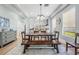Bright dining room features a long wood table, bench seating, and modern light fixtures at 5528 Liberty Plain Cir, Tampa, FL 33611