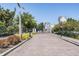 View of gated entrance to community with lush landscaping and brick-paved street at 5528 Liberty Plain Cir, Tampa, FL 33611