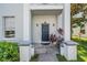 Inviting entryway with a stylish front door, potted plants, and well-maintained landscaping at 5528 Liberty Plain Cir, Tampa, FL 33611