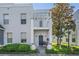 Charming townhome featuring a private balcony, front door entry, manicured lawn, and easy-to-access sidewalk at 5528 Liberty Plain Cir, Tampa, FL 33611