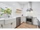 Bright kitchen featuring a farmhouse sink, stainless steel appliances, and floating shelves at 5528 Liberty Plain Cir, Tampa, FL 33611