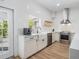 Well-lit kitchen with a farmhouse sink, stainless steel appliances, and convenient access to an outdoor space at 5528 Liberty Plain Cir, Tampa, FL 33611