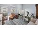 Bright living room featuring a patterned rug, two armchairs, a piano, a rocking chair and multiple large windows at 5528 Liberty Plain Cir, Tampa, FL 33611