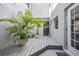 Outdoor patio with potted plants, a grill, and white stucco walls creating a tranquil and private space at 5528 Liberty Plain Cir, Tampa, FL 33611