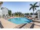 Community pool area with a large swimming pool, sun loungers, pergola and lush greenery at 5528 Liberty Plain Cir, Tampa, FL 33611