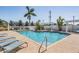 Inviting community pool with sun loungers, manicured landscaping, and a shaded pergola for ultimate relaxation at 5528 Liberty Plain Cir, Tampa, FL 33611