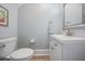 Clean powder room features a white vanity, brushed nickel faucet, and light gray walls at 5528 Liberty Plain Cir, Tampa, FL 33611