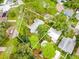 Beautiful aerial view of home with mature trees, fenced yard, and well-maintained landscaping in a desirable neighborhood at 5625 Atlantic N Ave, St Petersburg, FL 33703