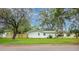 View of the side of the house from the backyard with a well-manicured lawn at 5625 Atlantic N Ave, St Petersburg, FL 33703