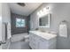 Contemporary bathroom featuring gray tile accents, a marble vanity, and modern lighting at 5625 Atlantic N Ave, St Petersburg, FL 33703