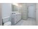 Bathroom featuring a glass block wall, a vanity, and tiled flooring at 5625 Atlantic N Ave, St Petersburg, FL 33703