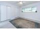 Bright bedroom featuring wood-look flooring, a ceiling fan, and large sliding-door closets at 5625 Atlantic N Ave, St Petersburg, FL 33703
