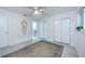 Bright bedroom with light wood floors, ample closet space, and a view into the bathroom at 5625 Atlantic N Ave, St Petersburg, FL 33703