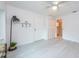 Spacious bedroom with wood-look floors, ceiling fan, and door to the bathroom at 5625 Atlantic N Ave, St Petersburg, FL 33703