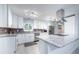 Beautiful white kitchen with stainless steel appliances, granite countertops, and light wood flooring at 5625 Atlantic N Ave, St Petersburg, FL 33703