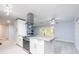 Modern kitchen with white cabinets, stainless steel appliances, granite countertops and light wood flooring at 5625 Atlantic N Ave, St Petersburg, FL 33703