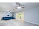Bright living room featuring stylish blue sofa, light wood floors and view into the sunroom at 5625 Atlantic N Ave, St Petersburg, FL 33703