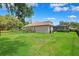 Well-maintained backyard with lush lawn, partial fence, and view of the screened-in lanai at 5823 Terncrest Dr, Lithia, FL 33547