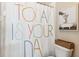 Charming bathroom with 'Today is Your Day' shower curtain and giraffe art print at 5823 Terncrest Dr, Lithia, FL 33547