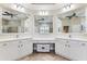 Elegant primary bathroom featuring double vanities, granite countertops, and ample cabinet space at 5823 Terncrest Dr, Lithia, FL 33547