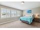 Comfortable bedroom with a large window, neutral walls, and plush carpeting at 5823 Terncrest Dr, Lithia, FL 33547