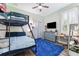 Fun bedroom featuring a bunk bed, desk area, and unique accent lighting at 5823 Terncrest Dr, Lithia, FL 33547
