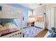 Shared bedroom with blue accent walls and white bunk beds over a plush colorful rug at 5823 Terncrest Dr, Lithia, FL 33547