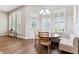 Cozy breakfast nook featuring a built-in banquette, round table, and bright, shuttered windows and glass-paned exterior door at 5823 Terncrest Dr, Lithia, FL 33547