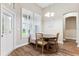 Cozy breakfast nook featuring a built-in banquette, round table, and bright, shuttered windows and glass-paned exterior door at 5823 Terncrest Dr, Lithia, FL 33547