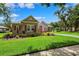 Beautiful single-story home featuring lush landscaping, a well-manicured lawn, and a welcoming driveway at 5823 Terncrest Dr, Lithia, FL 33547
