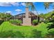 Exterior rear view showcasing the screened-in lanai and well-maintained landscaping in the backyard at 5823 Terncrest Dr, Lithia, FL 33547