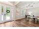 Welcoming foyer featuring hardwood floors, double doors, natural light, and a view of a home office at 5823 Terncrest Dr, Lithia, FL 33547