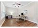 Bright home office with hardwood floors, plantation shutters, and a stylish desk setup at 5823 Terncrest Dr, Lithia, FL 33547