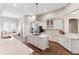 Bright, open kitchen with white cabinets, granite countertops, stainless steel appliances, and a large island with gas cooktop at 5823 Terncrest Dr, Lithia, FL 33547