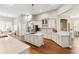 Bright, open kitchen with white cabinets, granite countertops, stainless steel appliances, and a large island with gas cooktop at 5823 Terncrest Dr, Lithia, FL 33547