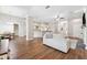 Open-concept living room with hardwood floors, neutral walls, and recessed lighting flows into the kitchen and breakfast nook at 5823 Terncrest Dr, Lithia, FL 33547