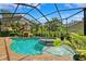 Stunning screened-in pool with spa, water feature, and outdoor fireplace at 5823 Terncrest Dr, Lithia, FL 33547