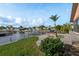 Waterfront backyard with stone grill, lush landscaping and boat dock at 6340 Garland Ct, New Port Richey, FL 34652