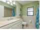 Bathroom featuring a vanity with stone countertop, window, and decorative mirror at 6340 Garland Ct, New Port Richey, FL 34652