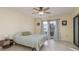 Bright bedroom featuring sliding glass doors to lanai, tile flooring, and a ceiling fan at 6340 Garland Ct, New Port Richey, FL 34652