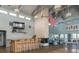 Clubhouse lounge area with a stone fireplace, bar seating, high ceilings, and an American flag at 6340 Garland Ct, New Port Richey, FL 34652